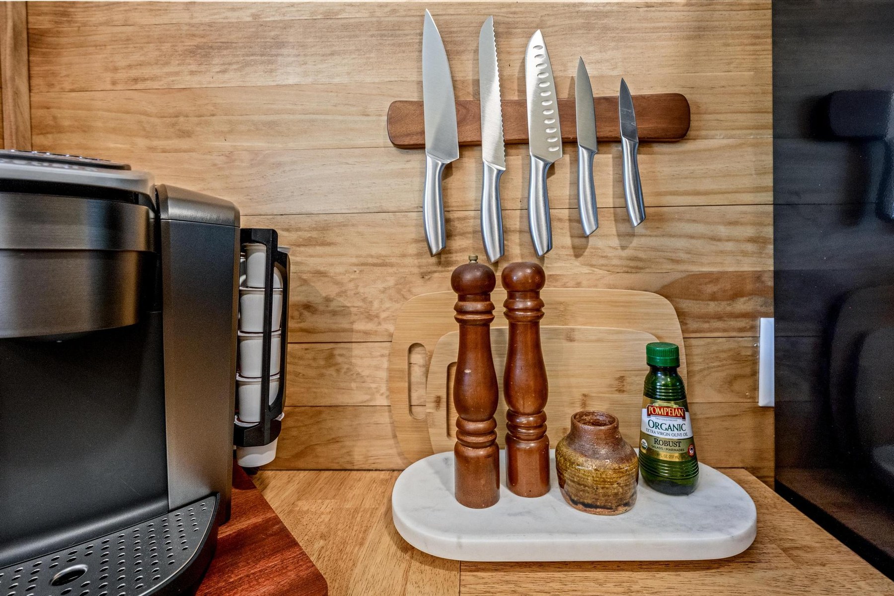 Kitchen details with knives, oil, salt and pepper